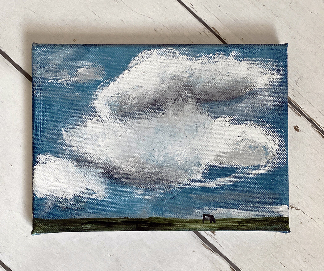 roundy clouds with 1 cow & grass